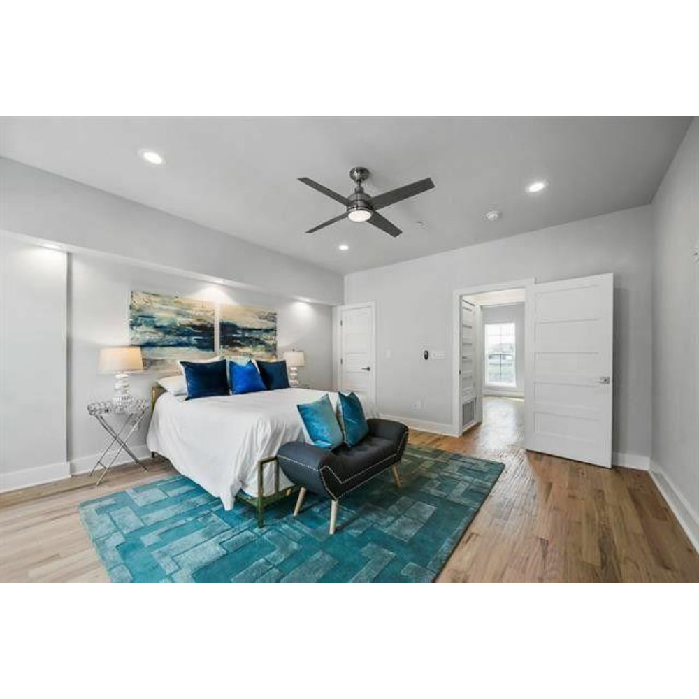 Contemporary bedroom with teal geometric rug